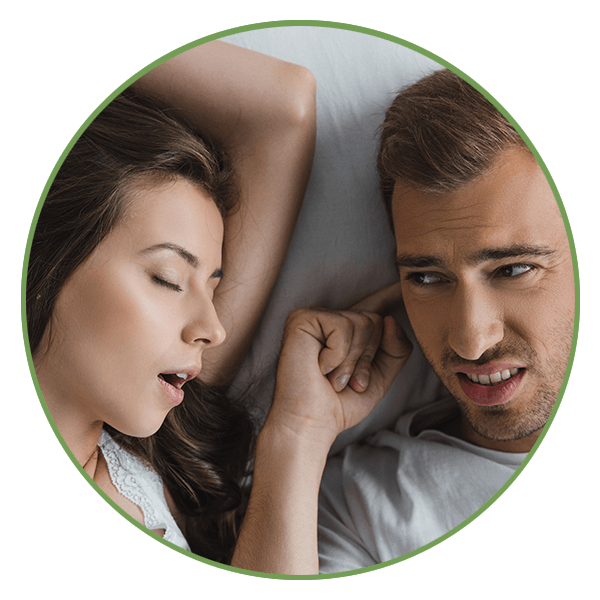 A man being kept awake by his partner snoring